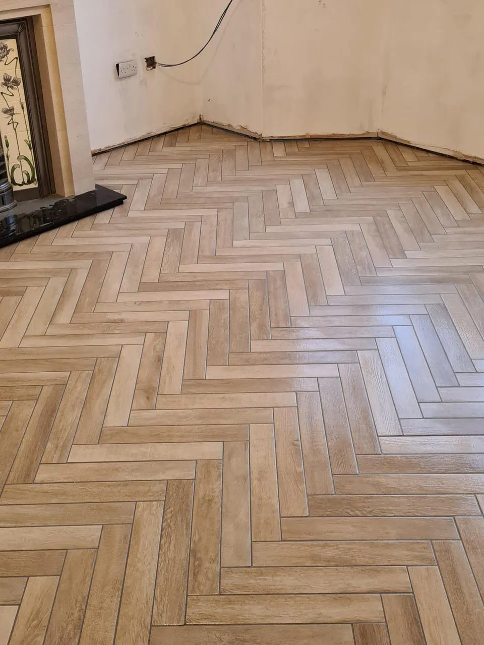 Herringbone wood floor detail at the transition — Fenelon Handyman Services, Tampa Bay, FL