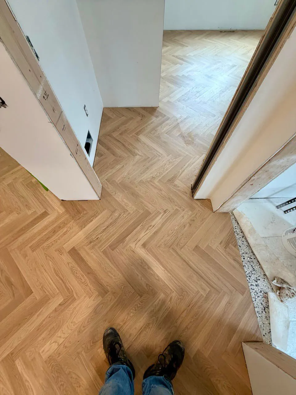 Completed herringbone wood flooring through living areas — Fenelon Handyman Services, Tampa Bay, FL