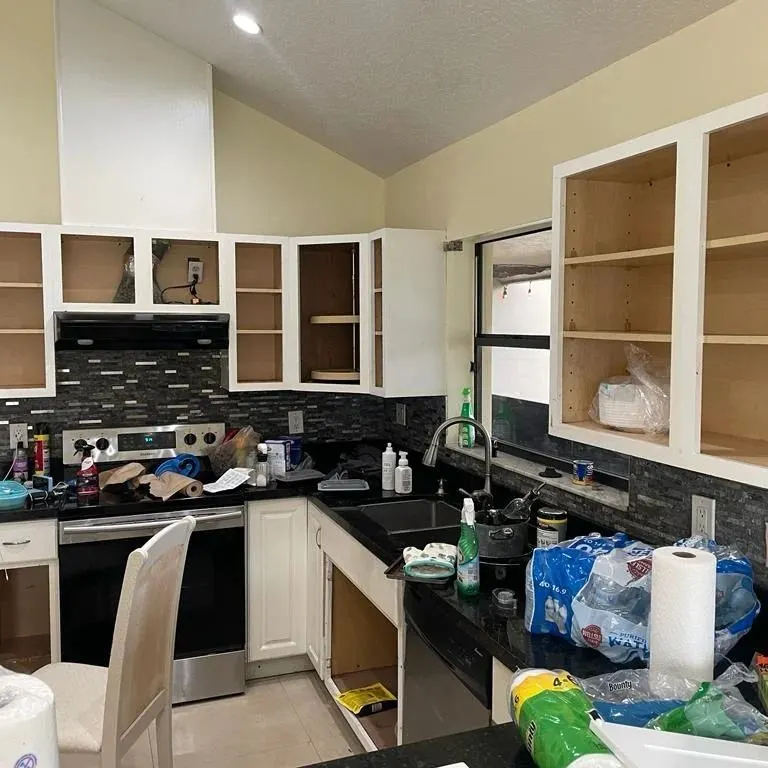 Kitchen cabinet painting in progress — doors off and surfaces prepped — Fenelon Handyman Services, Tampa Bay, FL