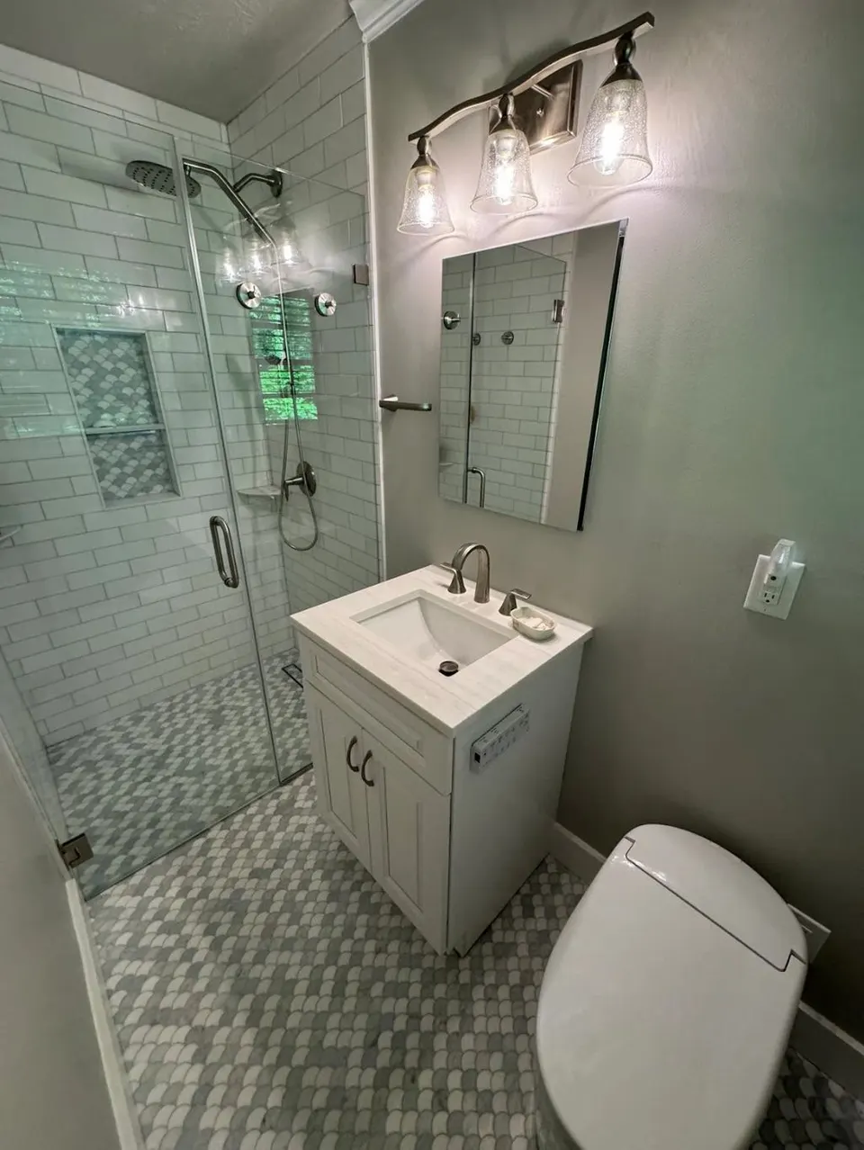 Completed bathroom with glass shower, new vanity and toilet — Fenelon Handyman Services, Tampa Bay, FL
