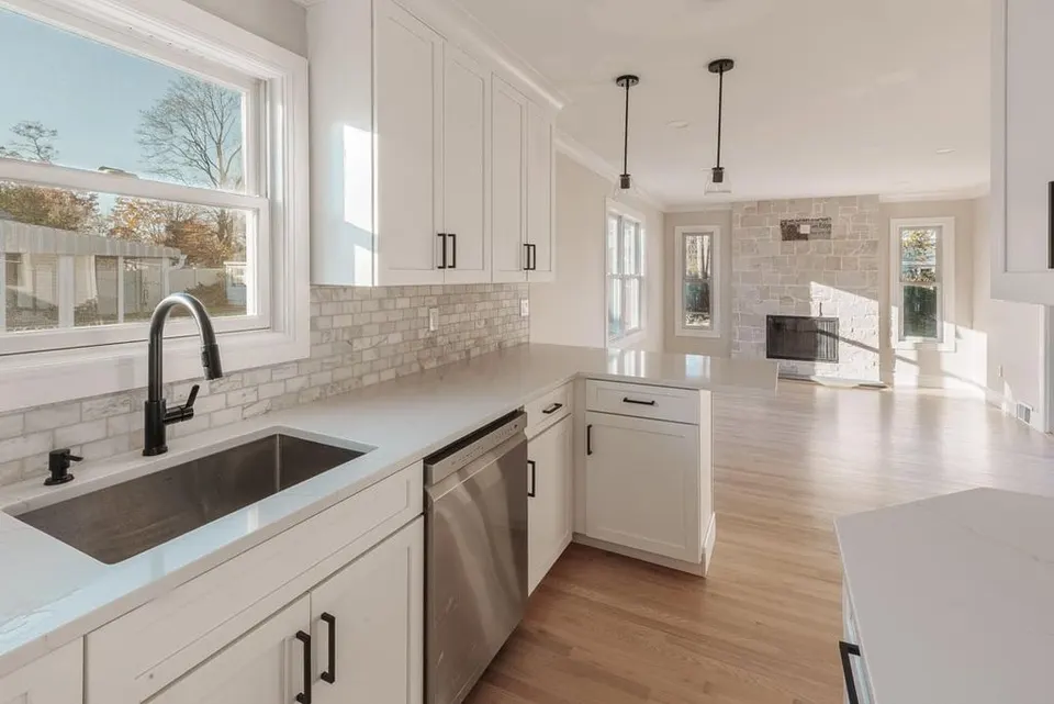 Kitchen remodel with white cabinetry and island seating — Fenelon Handyman Services, Tampa Bay, FL