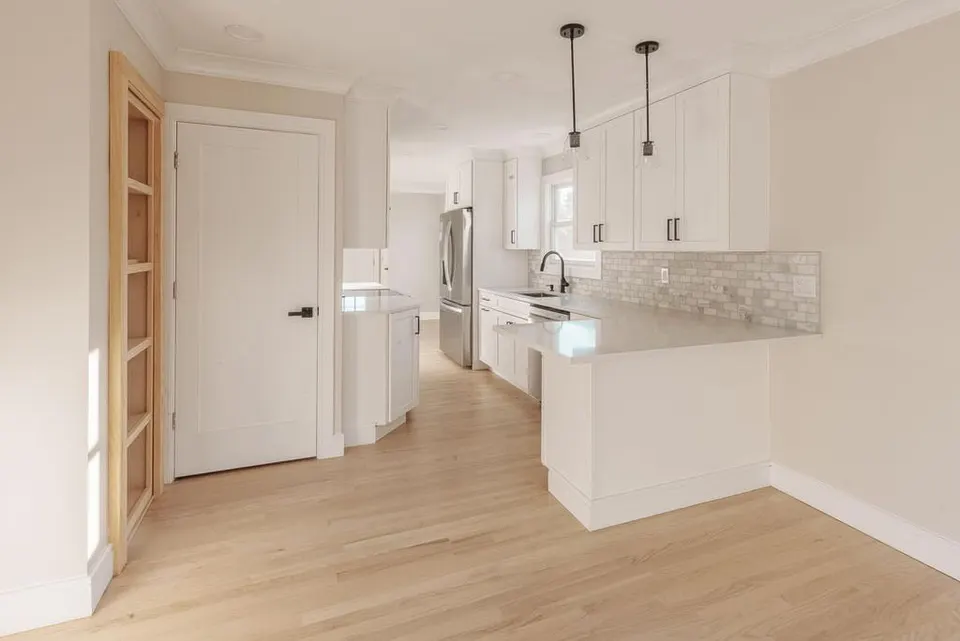 Finished kitchen remodel with island pendants and quartz counters — Fenelon Handyman Services, Tampa Bay, FL