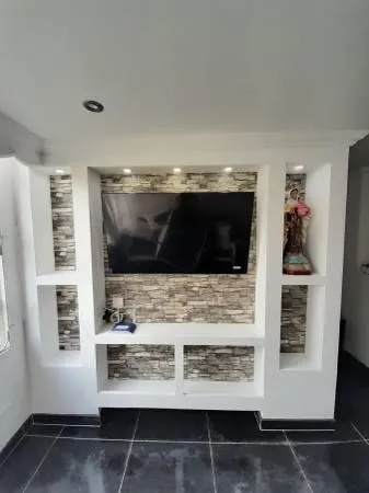 Custom built-in media wall with mounted TV and display niches — Fenelon Handyman Services, Tampa Bay, FL