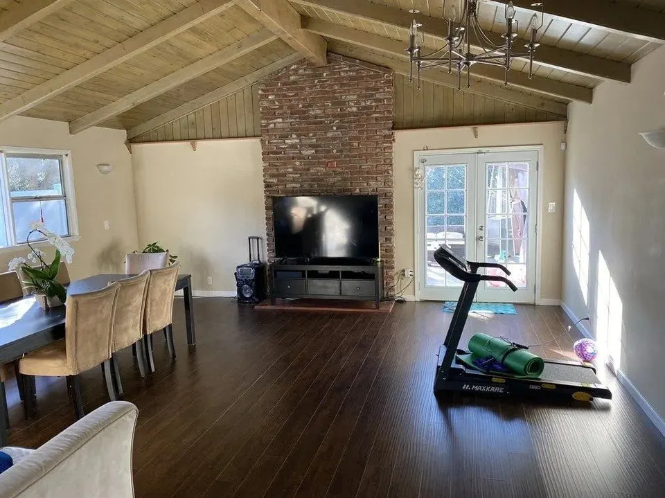 Living room media area by the brick fireplace after a room refresh — Fenelon Handyman Services, Tampa Bay, FL