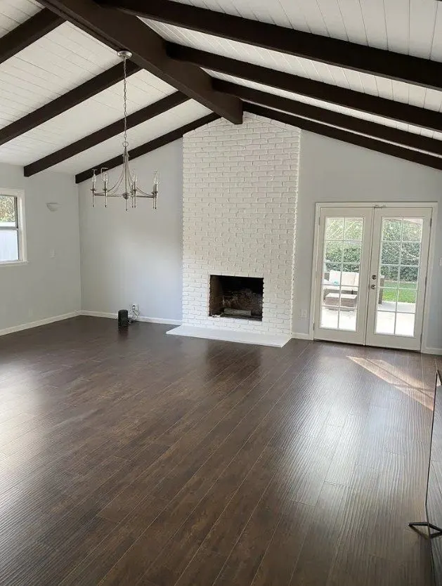 Vaulted living room with painted brick fireplace ready for the media setup — Fenelon Handyman Services, Tampa Bay, FL